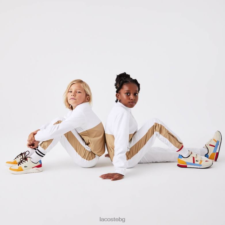 деца Lacoste бяло/бежово панталони с контрастна лента облекло XTV623224